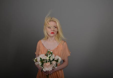 Girl in lilac dress posing in photo studioの写真素材