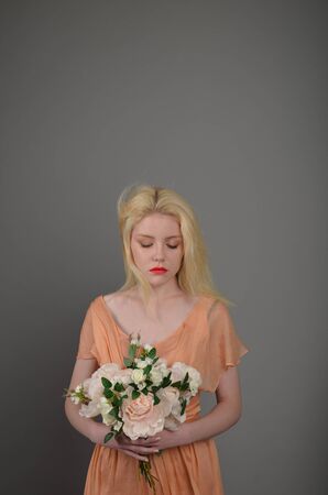 Girl in lilac dress posing in photo studioの写真素材