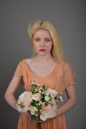 Girl in lilac dress posing in photo studioの写真素材