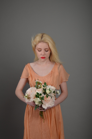 Girl in lilac dress posing in photo studioの写真素材