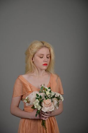Girl in lilac dress posing in photo studioの写真素材