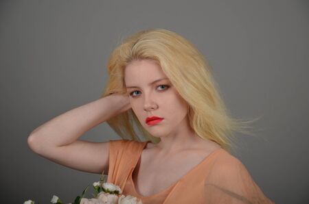 Girl in lilac dress posing in photo studioの写真素材