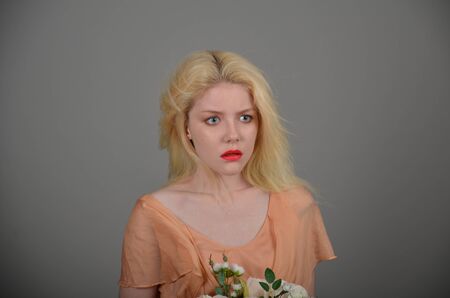 Girl in lilac dress posing in photo studioの写真素材
