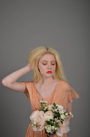 Girl in lilac dress posing in photo studioの写真素材