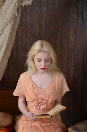 Girl in lilac dress posing in photo studioの写真素材