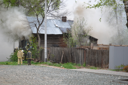 Fireman extinguishes a fire Fireman extinguishes a fireの写真素材