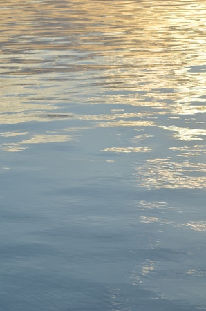 reflection of blue sky with white clouds in water, abstract background.の写真素材