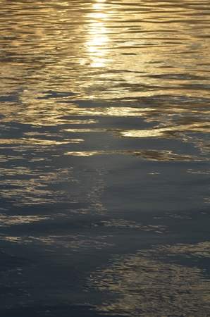 reflection of blue sky with white clouds in water, abstract background.の写真素材