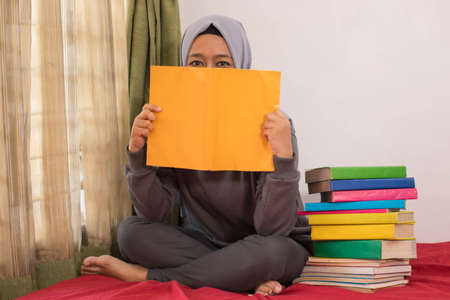 hijab asian women working from home using laptops and booksの写真素材