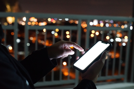 Asian girl hand holding mobile phoneの写真素材