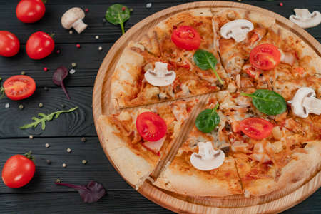 Pizza with Mozzarella cheese, with mushrooms, tomatoes, herbs and pepperoni spices.の写真素材