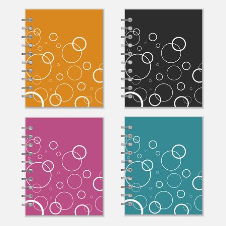 Set of four colorful spiral notebook covers with white circles. Isolated on whiteのイラスト素材