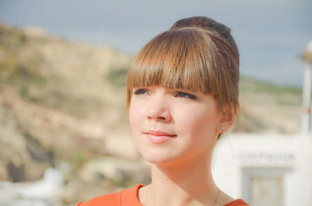 Portrait of beautiful young woman at the quay