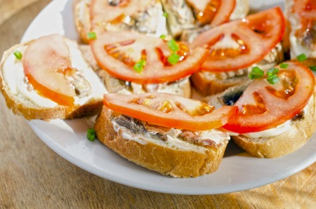 Tasty sandwich from with sprats and tomatoの写真素材
