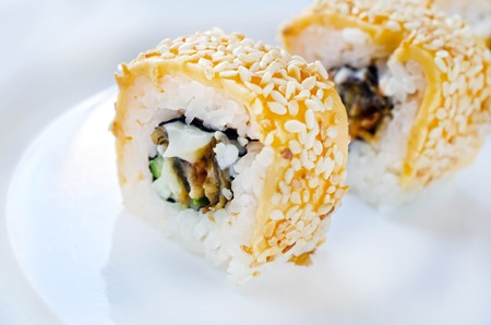 Close up of tasty fresh sushi rolls on white plateの写真素材