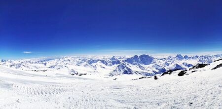 People snowboarding on snow of beautiful slopes of the Caucasus Mountainsの写真素材