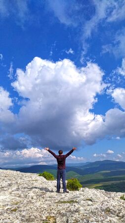 Man standing back over beautiful view of canyonの写真素材