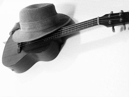 woven hat and acoustic ukulele put on white background,in abstract artd design,black and white tone.の写真素材