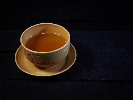 The clay chinese tea cup was put on black timber wooden board,in abstract art design,vintage and art style,の写真素材