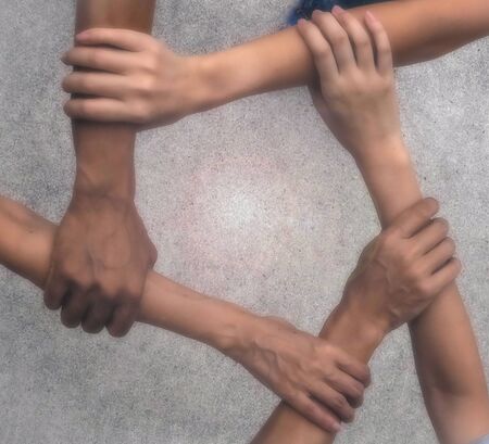 The blurred background of teamwork hands touch together,to be sign and symbol of friendship and the...