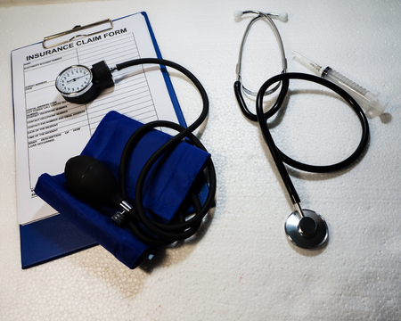 The pressure gauge put on Insurance claim form,on white background.の写真素材