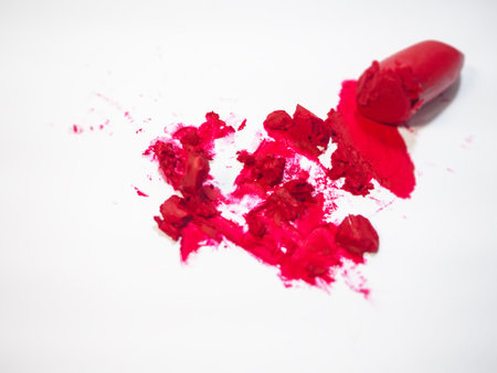 Close up cutted lipstick and splash on white background,show color and texture of product.blurry light around.の写真素材