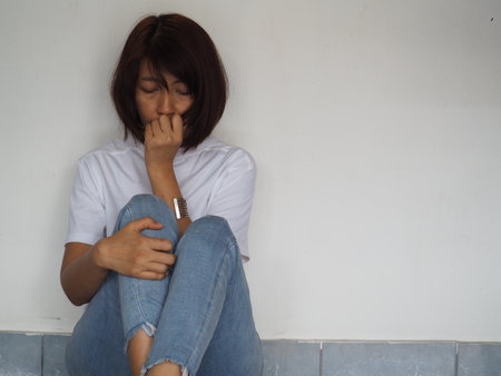 Portrait of thai adult beautiful girl White shirt blue jeans relax and smileの写真素材