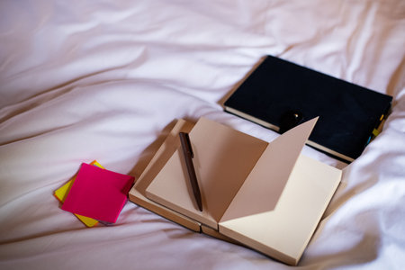 The opened book with pen put on bedの写真素材