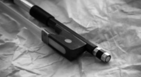 The blurry light design background of violin bow frog and violin bow screw,the end part of a...