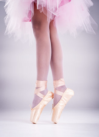 In selective focus of the lady legs with ballet shoes, standing with toes,for ballet basic patternの写真素材