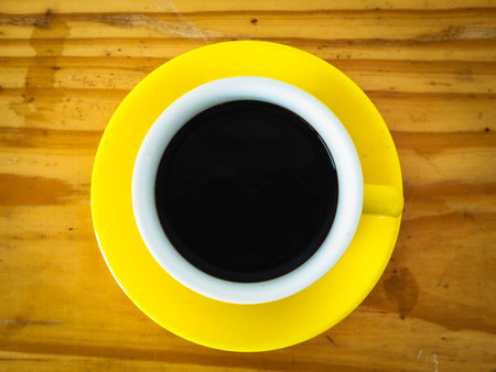 Single Yellow coffeecup put on wooden table.black aroma Hot drink.の写真素材