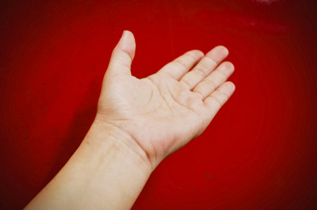 Human hand sign in front of background.