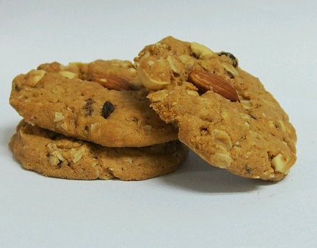 Whole wheat cookies on a white table.の素材