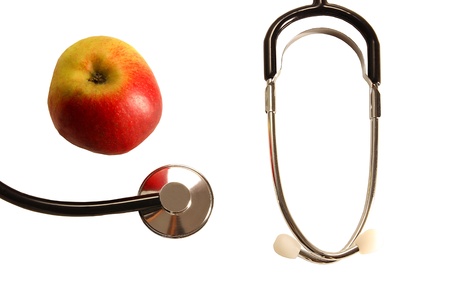 Stethoscope with apple on a table stands for healthy food 2の写真素材
