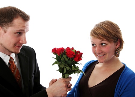 Man in a suit gives a bunch of flowers to a womenの写真素材