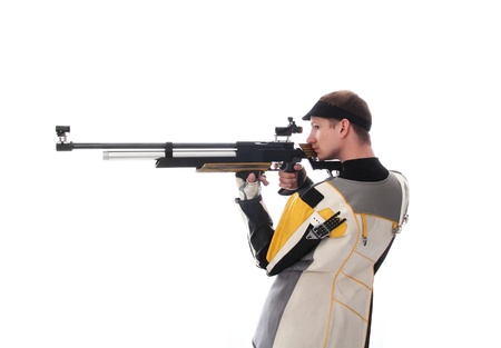 Man standing sideways taking aim with an air rifle isolated on whiteのeditorial素材