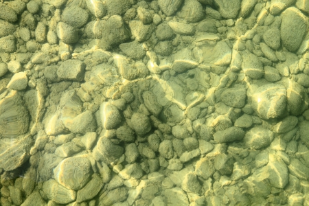 Stony pebbles underwater on the floor of a clean clear frshwater lake in the Starnerger Lakeの写真素材