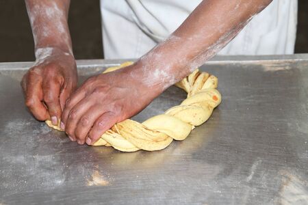 Baker forming a sweet dough mix