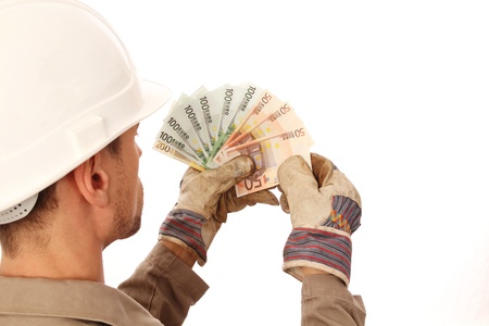 Construction worker counting money _ from behindの写真素材