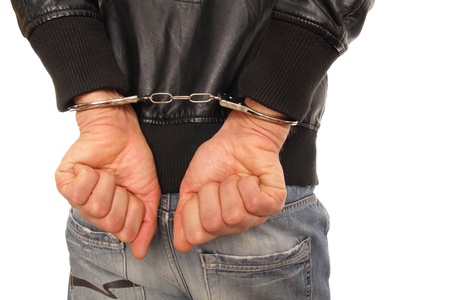 Man in leather jacket and Handcuffs behind his backの写真素材