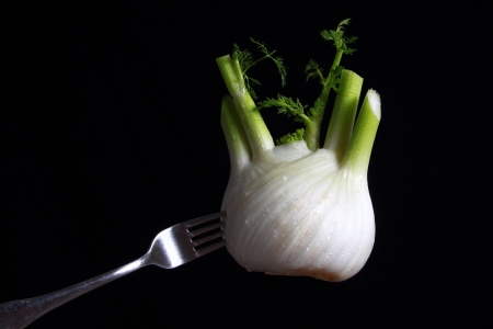 Fresh fennel speared on a forkの写真素材
