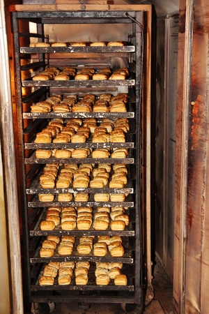 Fresh rolls in an industrial oven of a bakeryの写真素材