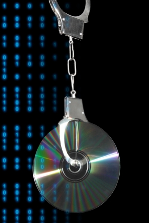 CD in handcuffs with written digital data の写真素材