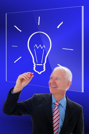 Businessman drawing on a glass plateの写真素材