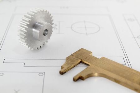 Cogwheel standing on a technical drawingの写真素材