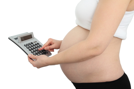 Pregnant woman with calculatorの写真素材
