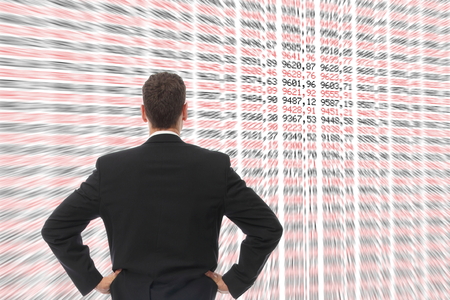 A Man in front of a big screen with numbersの写真素材