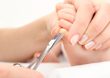 A Mother cutting theToenails of a Babyの写真素材
