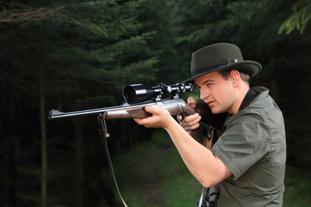 A Hunter shooting with his rifle