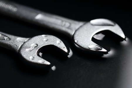 Two Wrenches as a Symbol for Teamwork in Business Groups